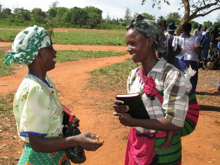 Two African women outside having a conversation